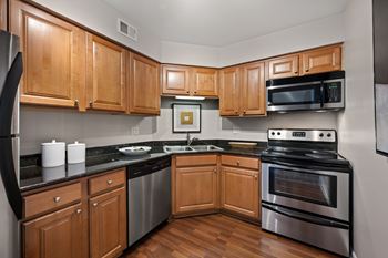 Renovated gourmet kitchens with maple cabinetry, granite countertops and brushed nickel hardware and fixtures